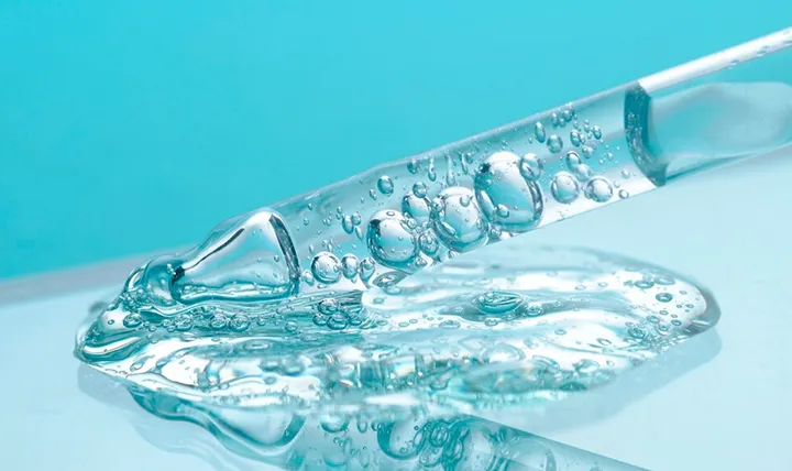 Close-up of a clear gel with bubbles on a surface.